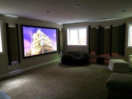 Basement theater features 4K, Acoustic panels, and LED lighting After